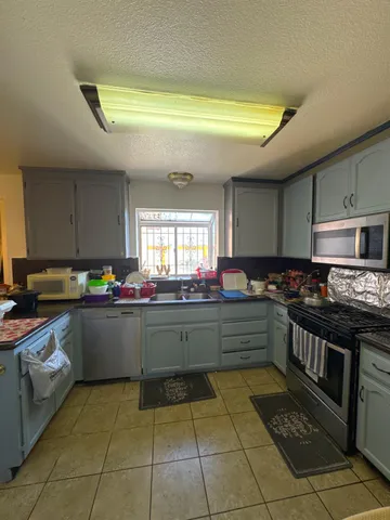 a kitchen with stainless steel appliances granite countertop a sink and cabinets
