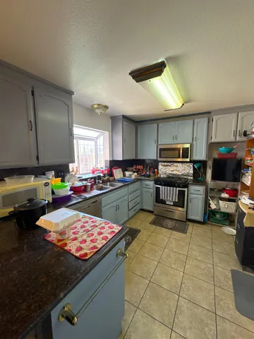 a kitchen with stainless steel appliances a stove a sink and a refrigerator