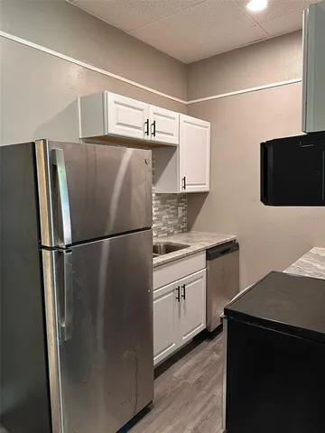 a kitchen with stainless steel appliances a refrigerator and a sink