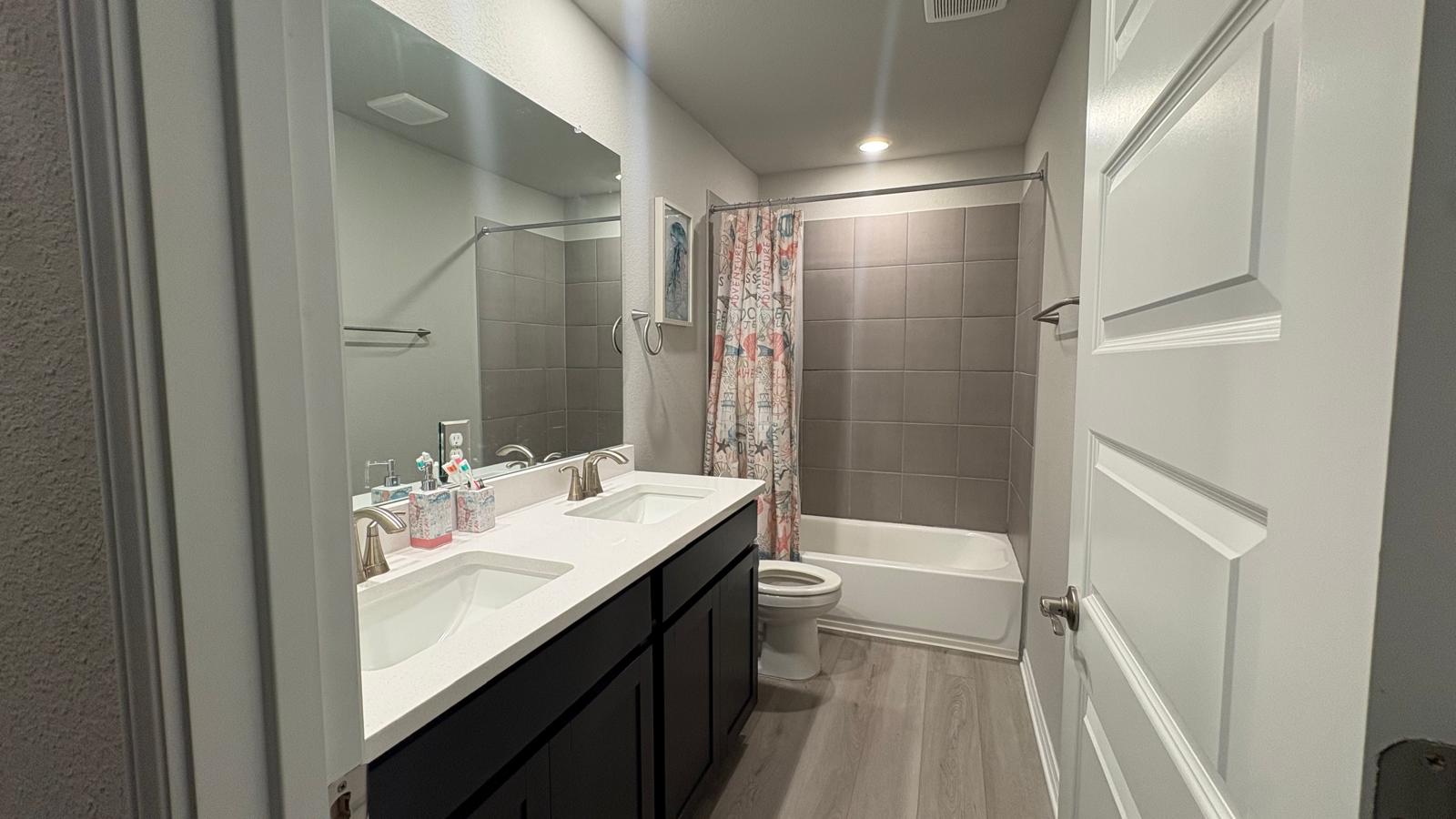 6511 Dragride Road Buda, TX 78610 - Photo 22 of 36 Dual vanity with bright lighting perfect for busy mornings.