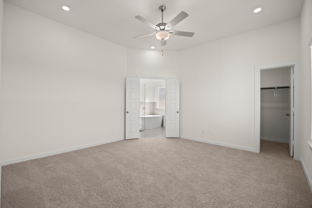 8311 Amber Summit Lane Angleton, TX 77515 - Photo 11 of 14 an empty room with a ceiling fan and a window