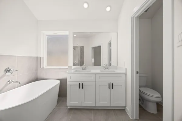a bathroom with a double vanity sink mirror and shower