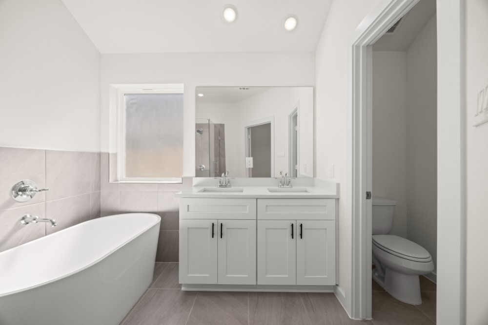 8311 Amber Summit Lane Angleton, TX 77515 - Photo 12 of 14 a bathroom with a granite countertop sink a toilet and bathtub