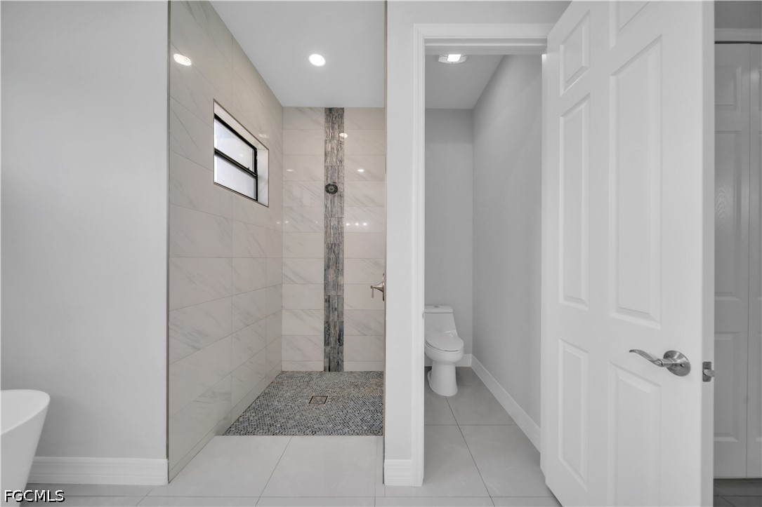 3509 38th Street Southwest Lehigh Acres, FL 33976 - Photo 23 of 47 a bathroom with a glass door shower