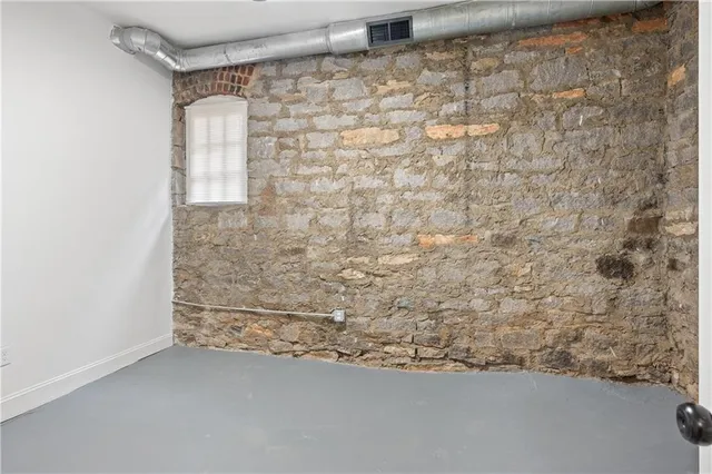 wooden floor in an empty room with a bathroom