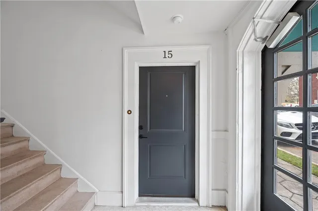 a view of a hallway with wooden floor and entryway