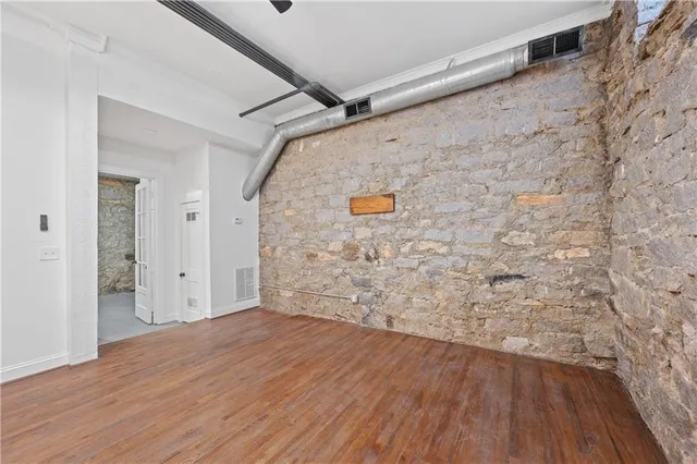 a view of kitchen with refrigerator and cabinets