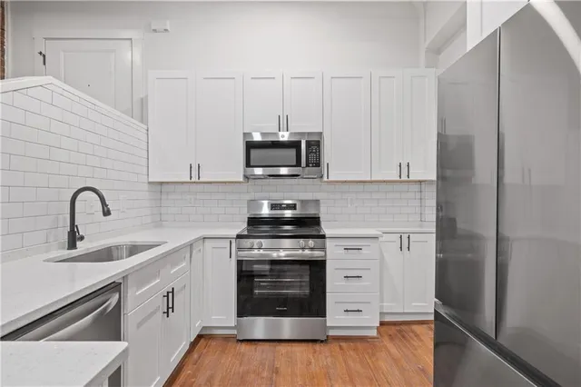 a kitchen with a sink cabinets and appliances