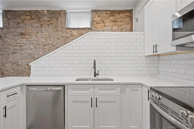 a kitchen with a sink cabinets and wooden floor
