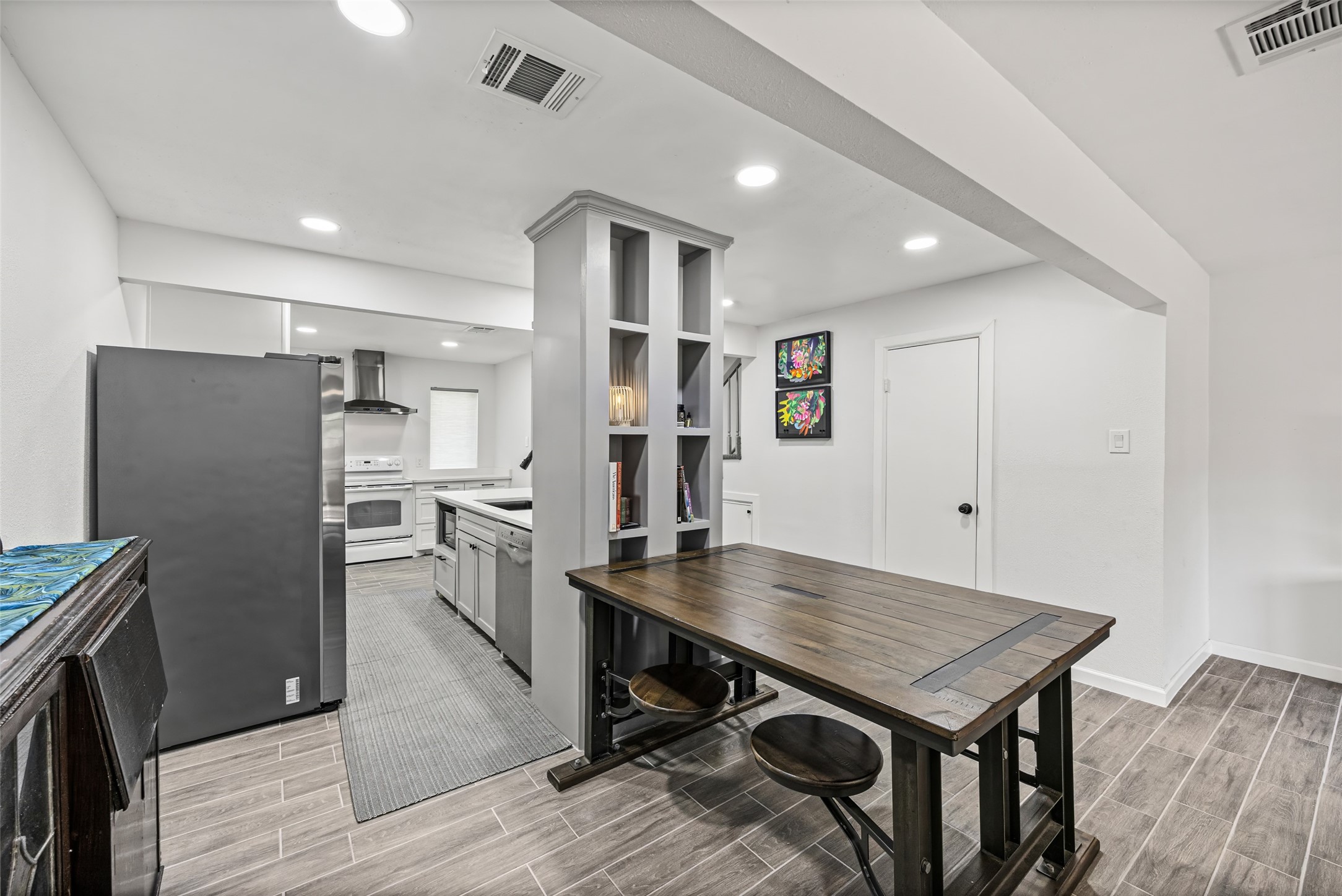 9501 Fondren Road, Unit 9 Houston, TX 77074 - Photo 11 of 29 a kitchen with refrigerator and wooden floor