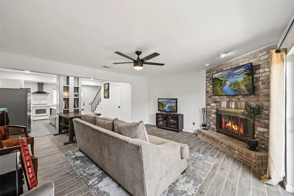 a living room with furniture a flat screen tv and a fireplace