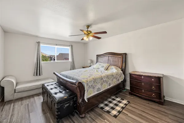 a bedroom with a bed dresser and a window