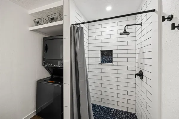 a bathroom with a shower and a sink