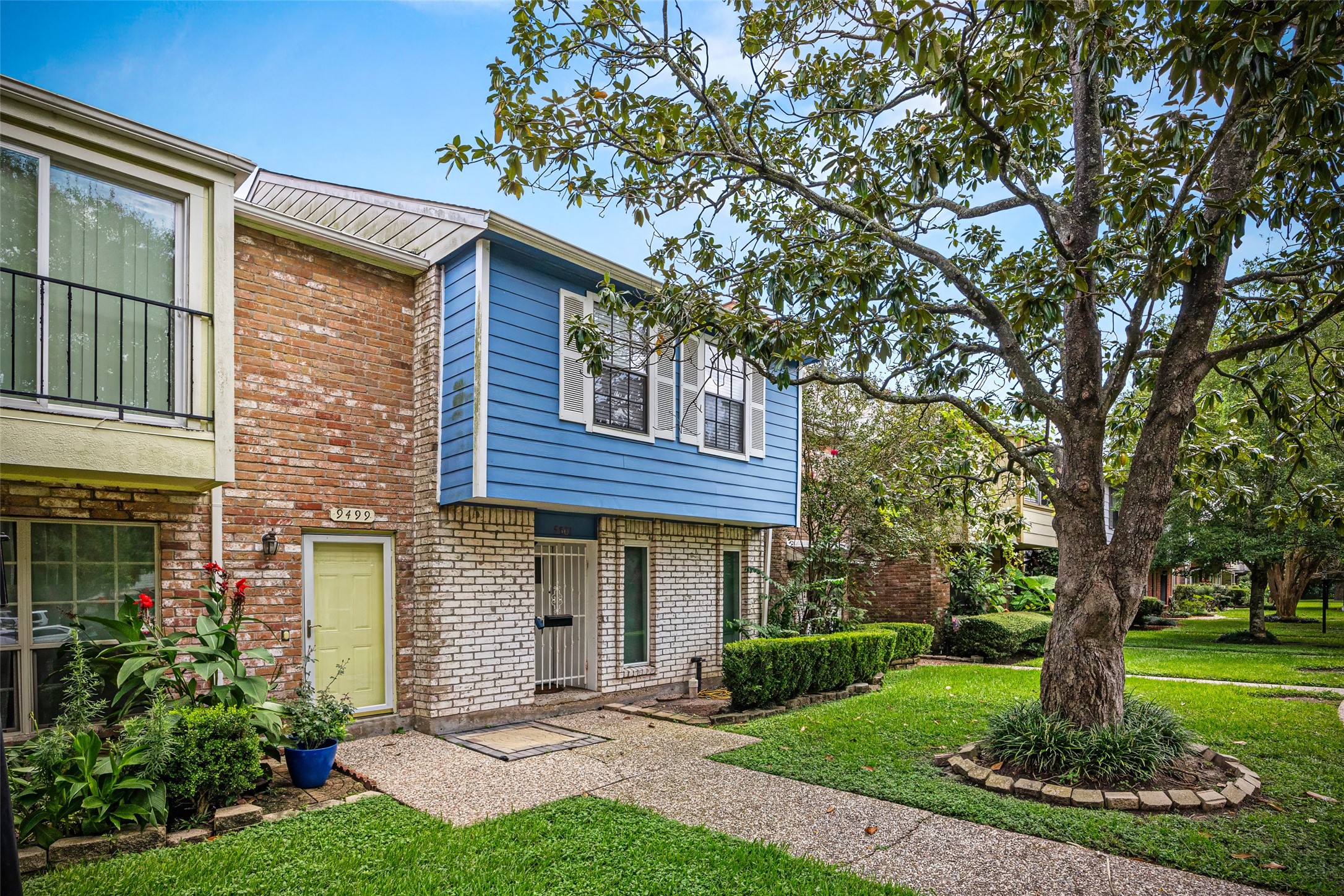 9501 Fondren Road, Unit 9 Houston, TX 77074 - Photo 2 of 29 a front view of a house with garden and trees