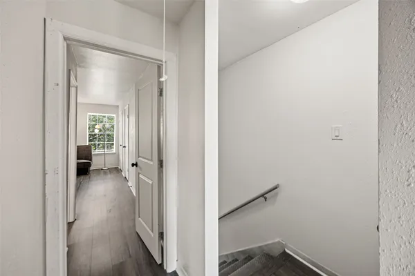 a view of a room with a hallway and toilet