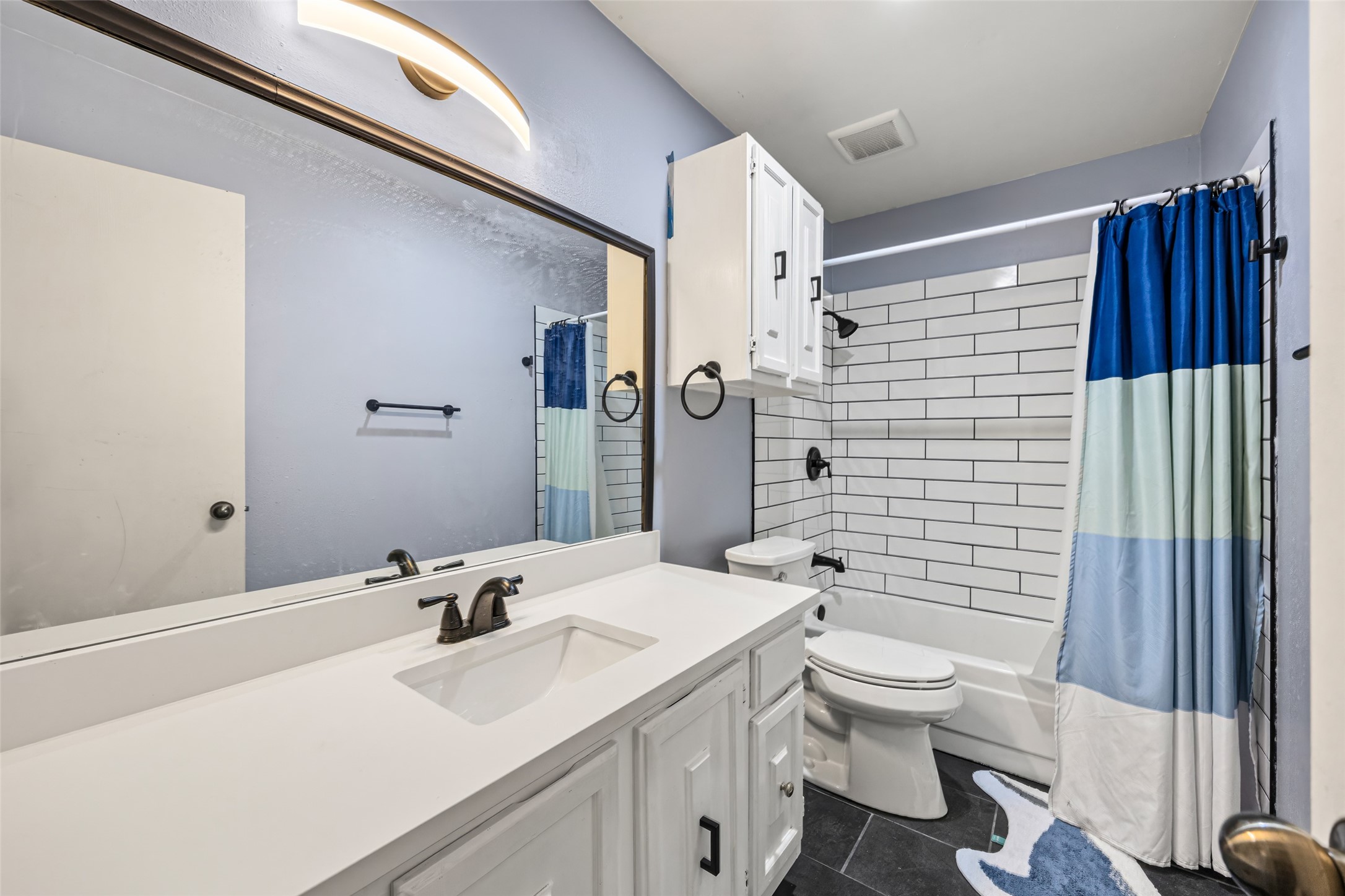 9501 Fondren Road, Unit 9 Houston, TX 77074 - Photo 22 of 29 a bathroom with a sink a toilet and shower