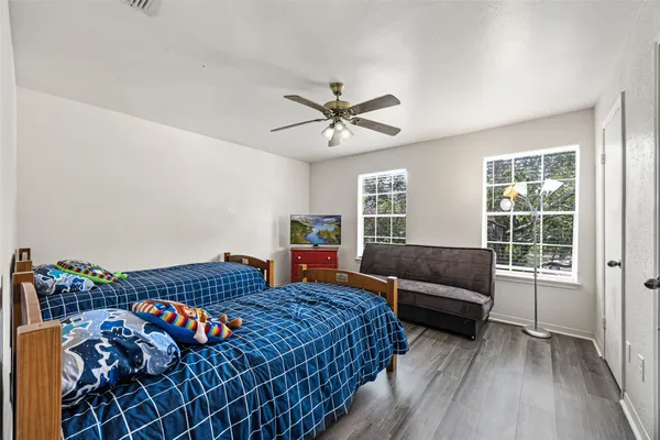 a bedroom with furniture and a large window