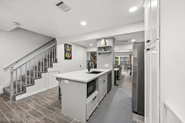a kitchen with counter top space and sink