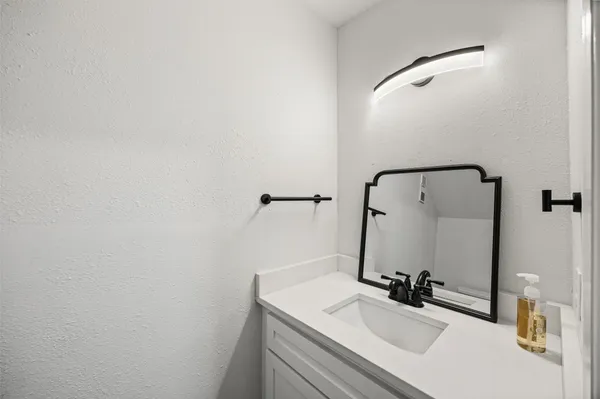 a bathroom with a sink and mirror