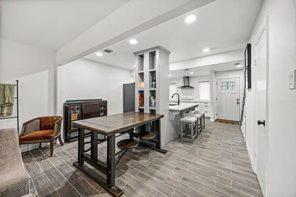 a view of a room with wooden floor and furniture