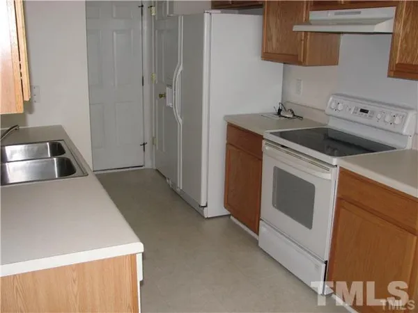 a kitchen that has a sink and a stove