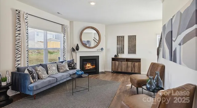 a living room with furniture fireplace and window