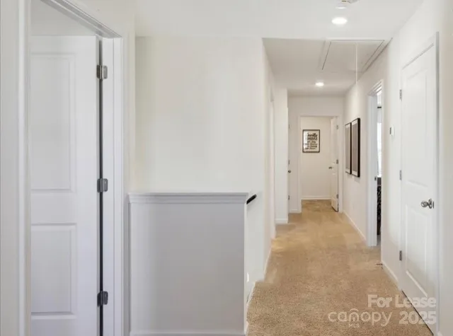 a view of a hallway with wooden shelves
