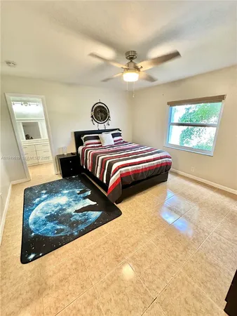 a bedroom with a bed and chandelier