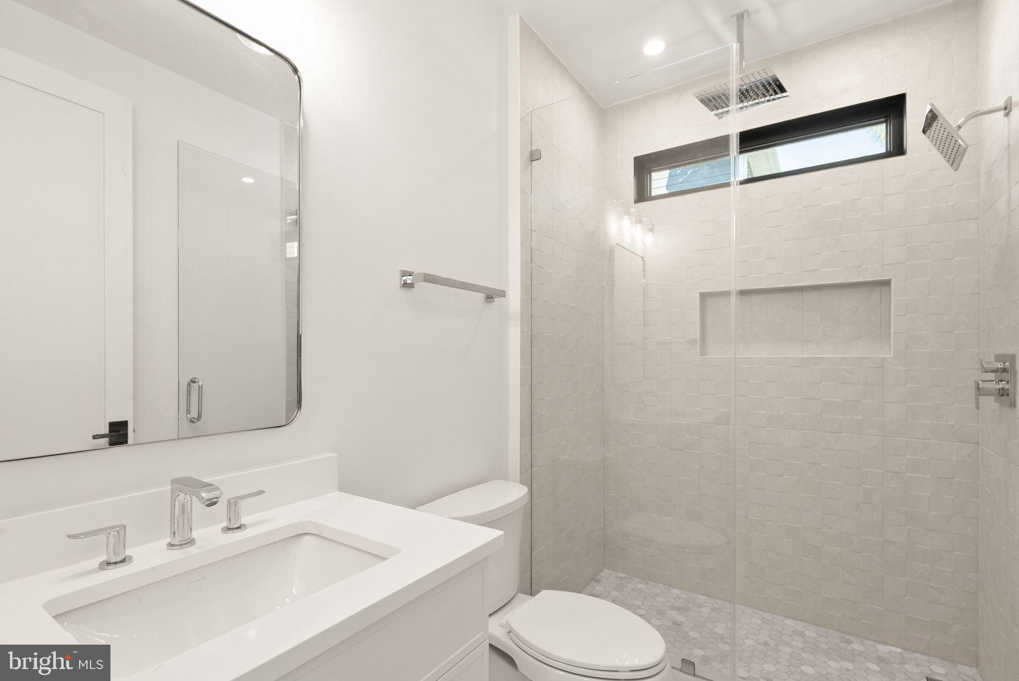 112 Elm Street Southwest Vienna, VA 22180 - Photo 30 of 96 a bathroom with a sink a toilet and shower