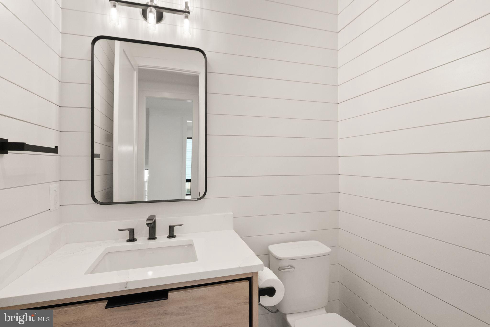 112 Elm Street Southwest Vienna, VA 22180 - Photo 31 of 96 a bathroom with a toilet sink and mirror