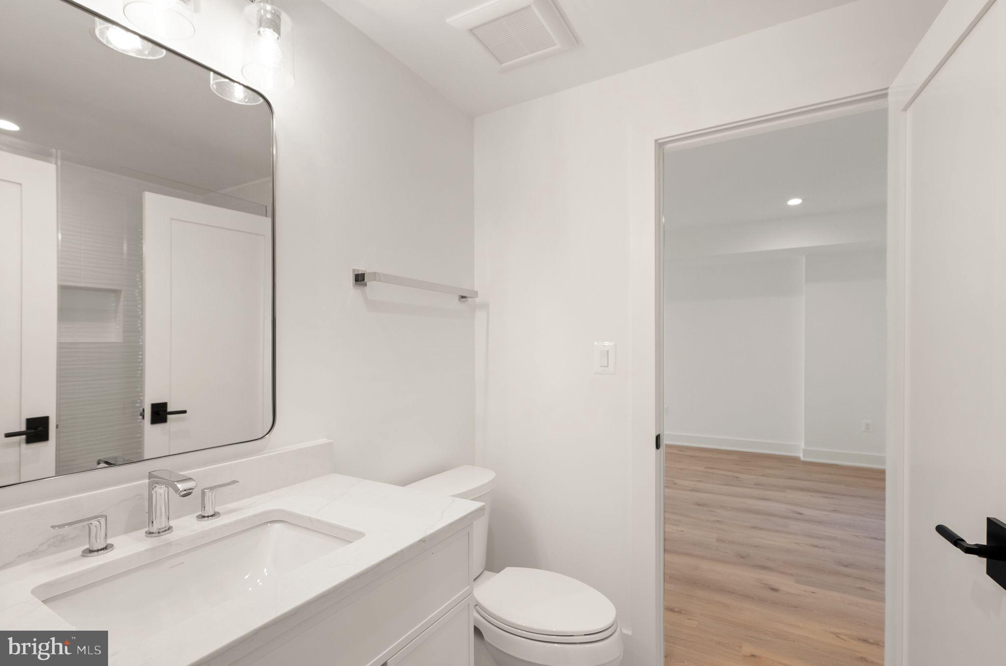 112 Elm Street Southwest Vienna, VA 22180 - Photo 79 of 96 a bathroom with a sink a toilet a mirror and vanity