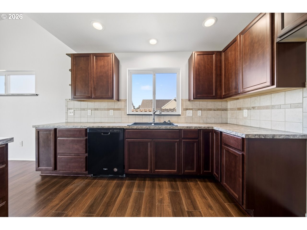 2679 Franklin Avenue Southwest Bandon, OR 97411 - Photo 12 of 48 a kitchen with granite countertop wooden cabinets a sink and dishwasher