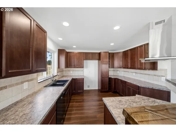 a kitchen with stainless steel appliances kitchen island granite countertop a sink counter space and cabinets