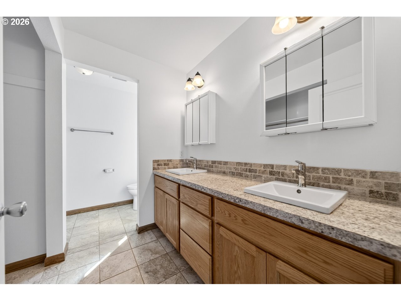 2679 Franklin Avenue Southwest Bandon, OR 97411 - Photo 21 of 48 a bathroom with a granite countertop sink and a mirror