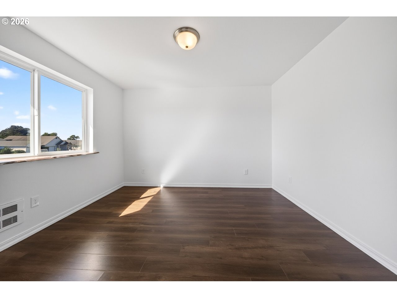 2679 Franklin Avenue Southwest Bandon, OR 97411 - Photo 28 of 48 a view of an empty room with wooden floor and a window