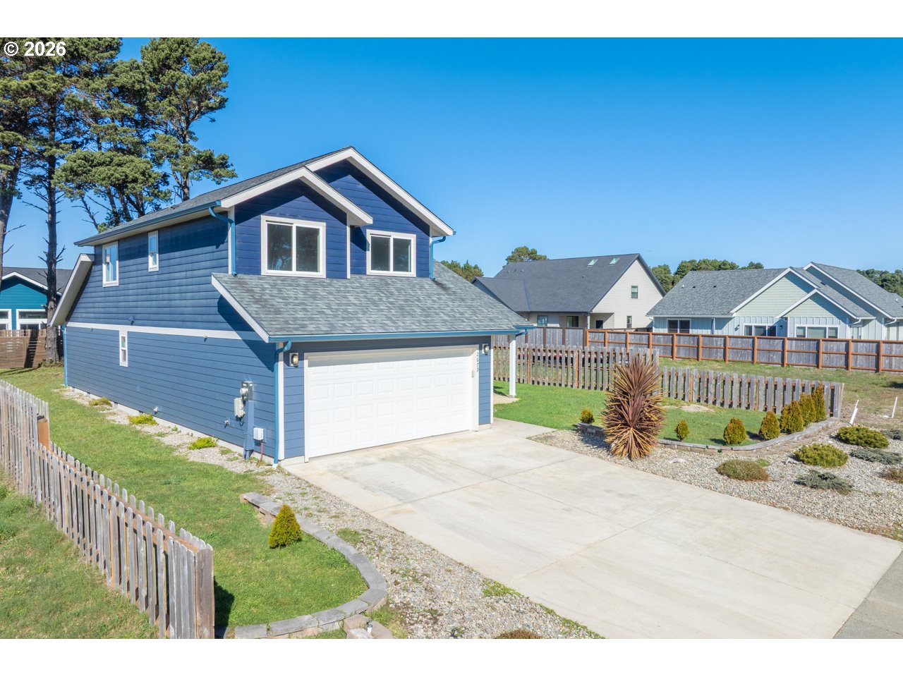 2679 Franklin Avenue Southwest Bandon, OR 97411 - Photo 3 of 48 a front view of a house with a yard and garage
