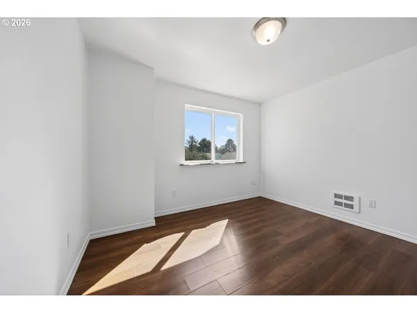 a view of an entryway with wooden floor