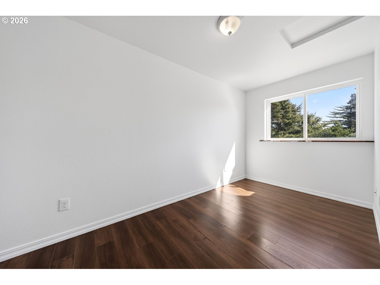 2679 Franklin Avenue Southwest Bandon, OR 97411 - Photo 38 of 48 a view of an empty room with wooden floor and a window