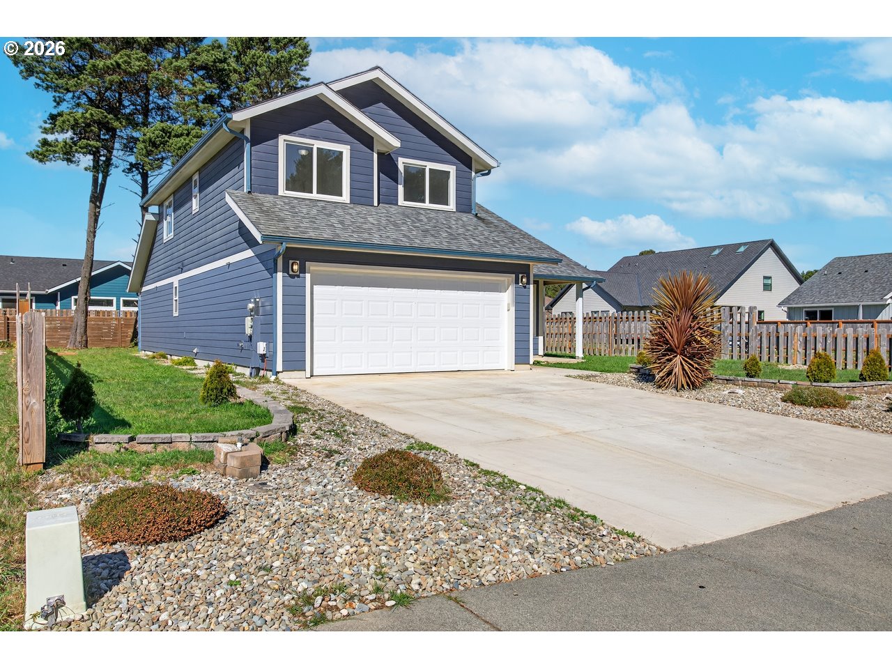 2679 Franklin Avenue Southwest Bandon, OR 97411 - Photo 48 of 48 a front view of a house with a yard and garage