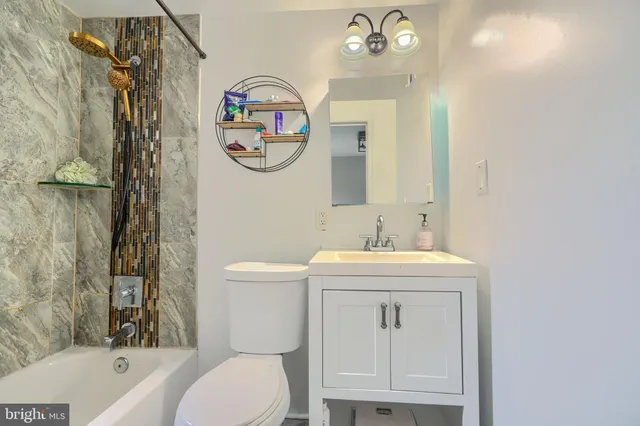 a bathroom with a toilet a sink and a mirror