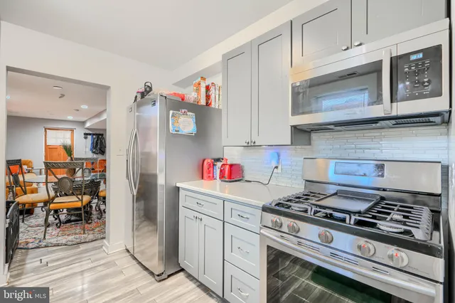 a kitchen with stainless steel appliances granite countertop a stove and cabinets