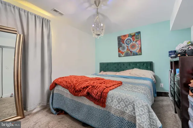 a bedroom with a bed dresser and a window