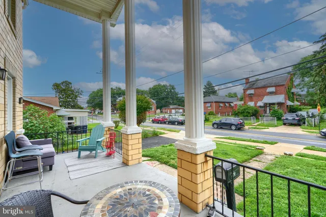 a view of a patio with a table and chairs potted plants with wooden floor