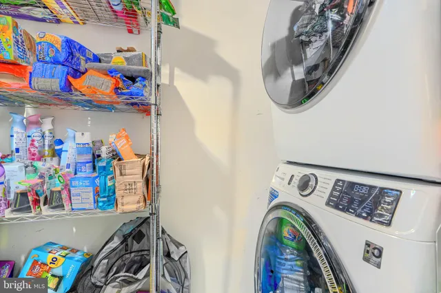 a utility room with dryer and baby bed