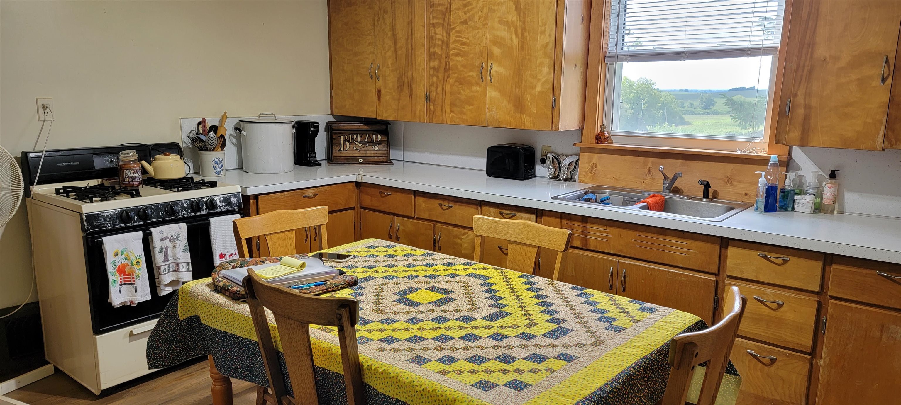 1966 North Heitter Road Lena, IL 61048 - Photo 5 of 27 a kitchen with stainless steel appliances kitchen island a table chairs in it and wooden floors