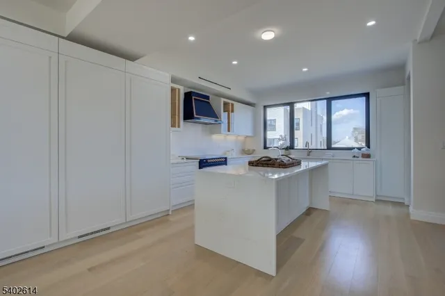 a kitchen with white cabinets and sink