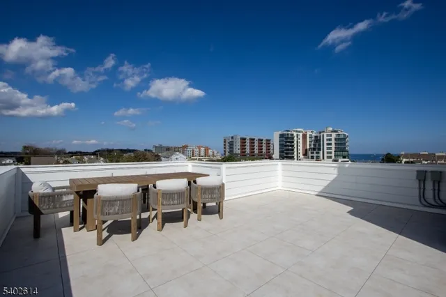 a bathroom with a granite countertop sink a toilet and bathtub