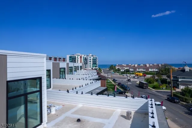 a terrace with outdoor seating and city view