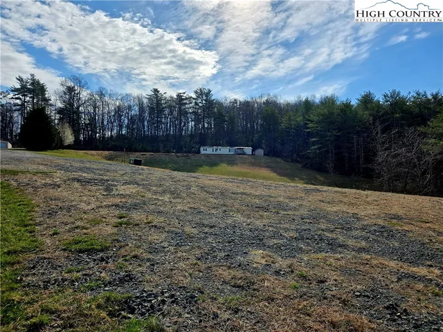 a view of a big yard with mountain view