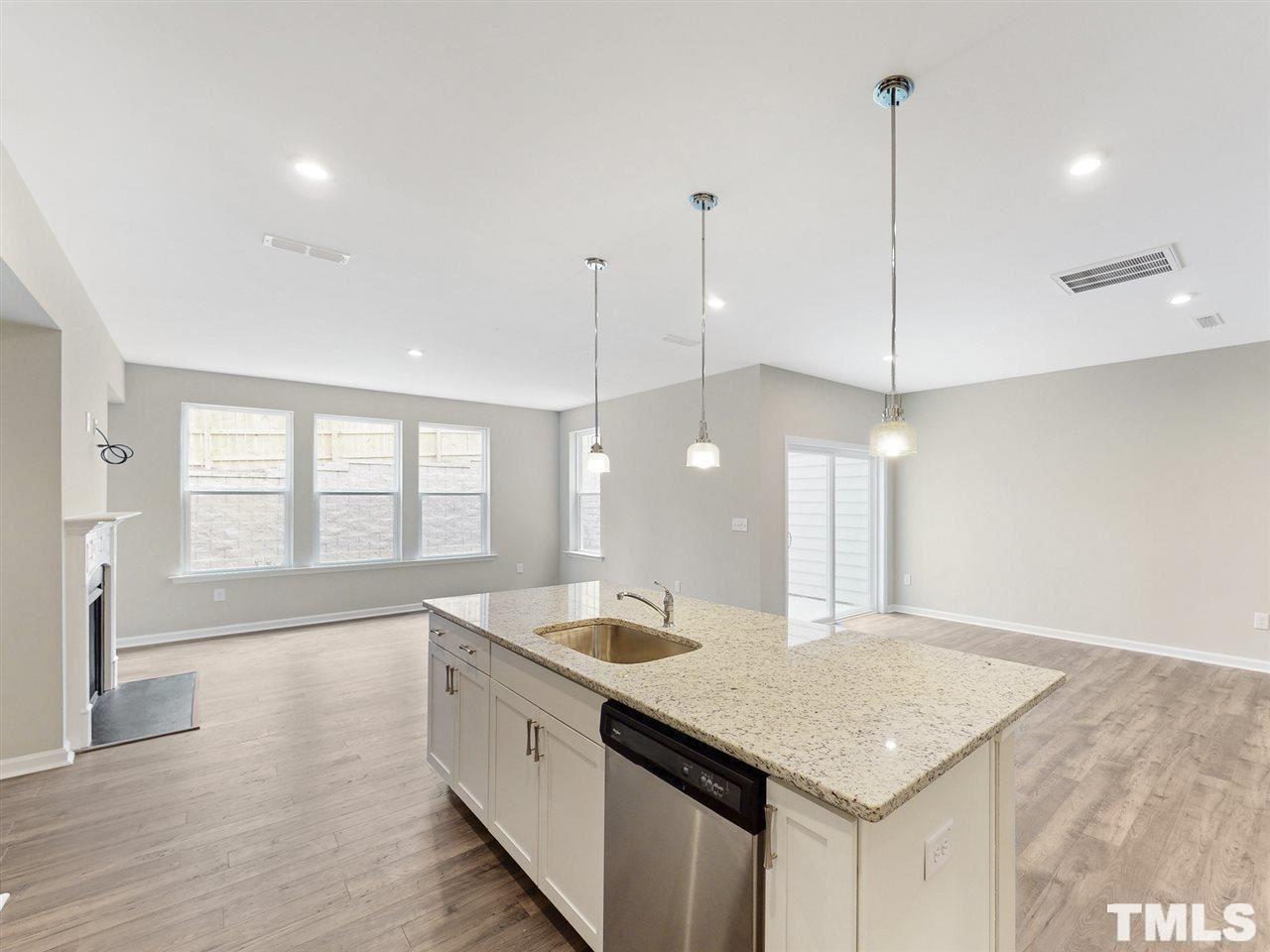 1605 Brussels Drive Apex, NC 27502 - Photo 3 of 17 a large kitchen with kitchen island a large island in it